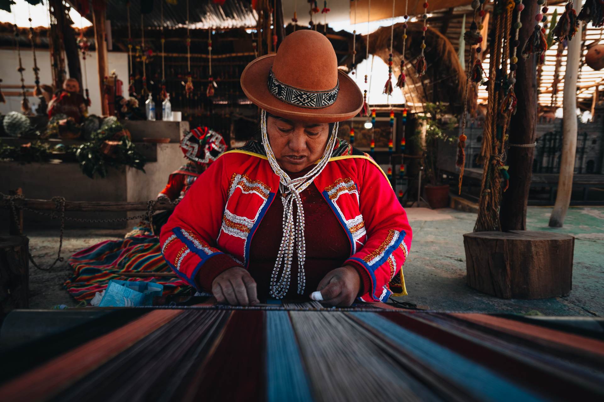 A weaver at a backstrap loom in the Sacred Valley