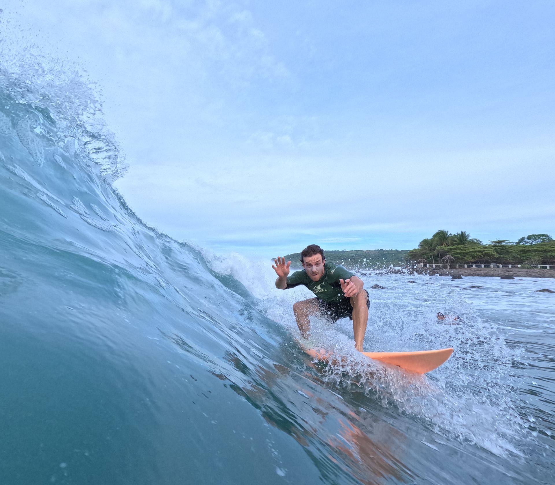 A surfer carving across a wave face