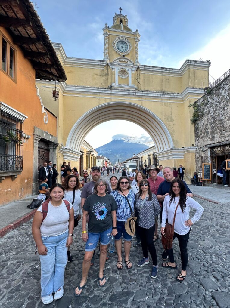 Group of people at historic arch in Antigua Guatemala
